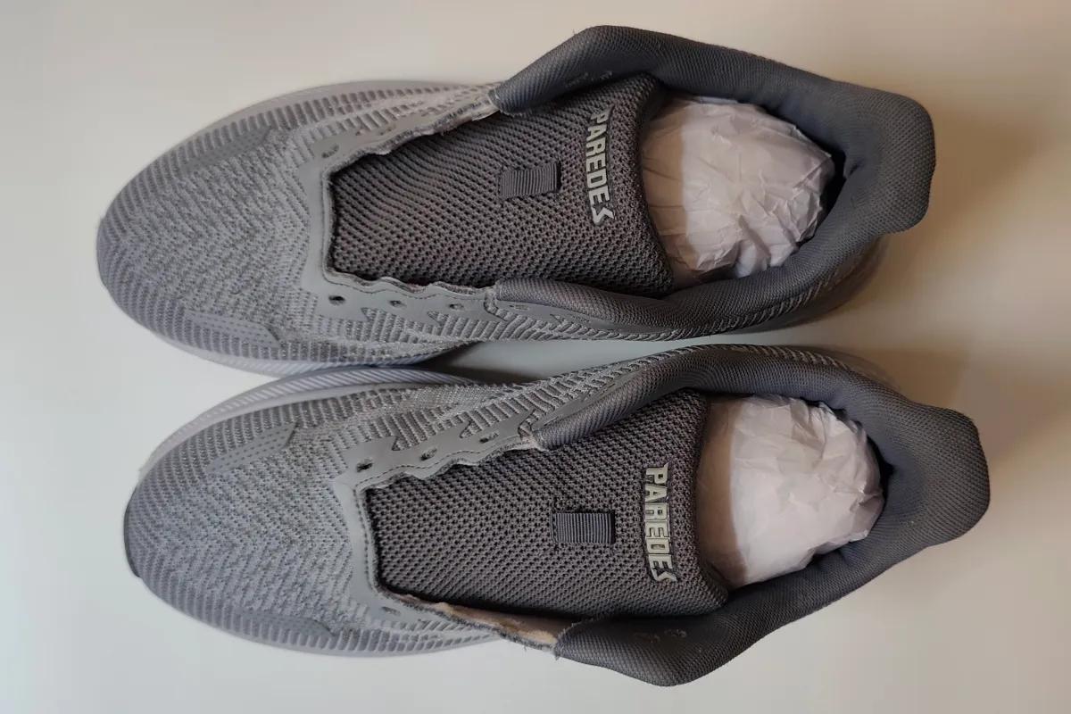 Clean grey mesh running shoe top view after machine washing showing bright white midsole restored