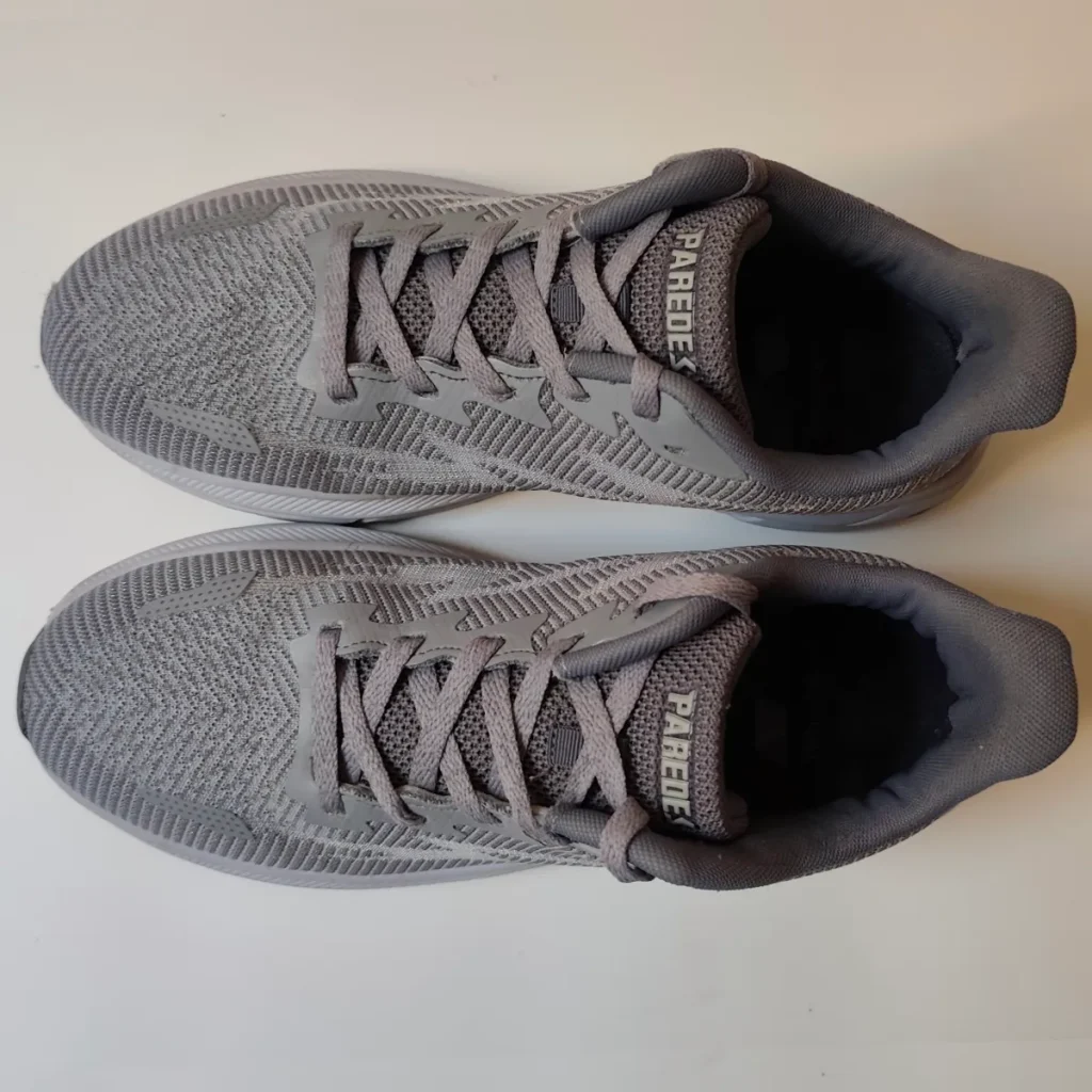 Clean grey mesh sneakers viewed from above after machine washing showing restored colour